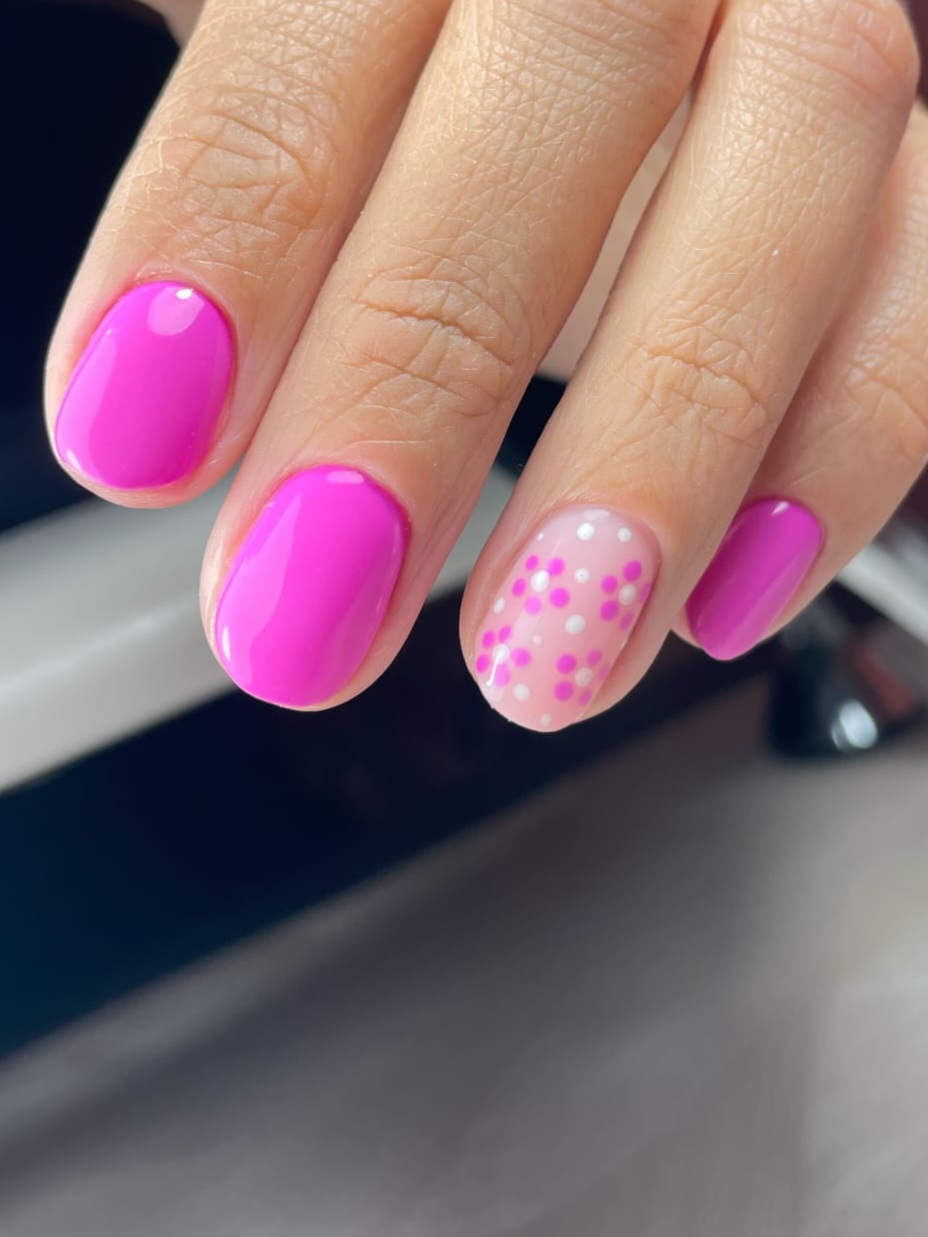 Felroze nagels met een gestippeld bloemdetail