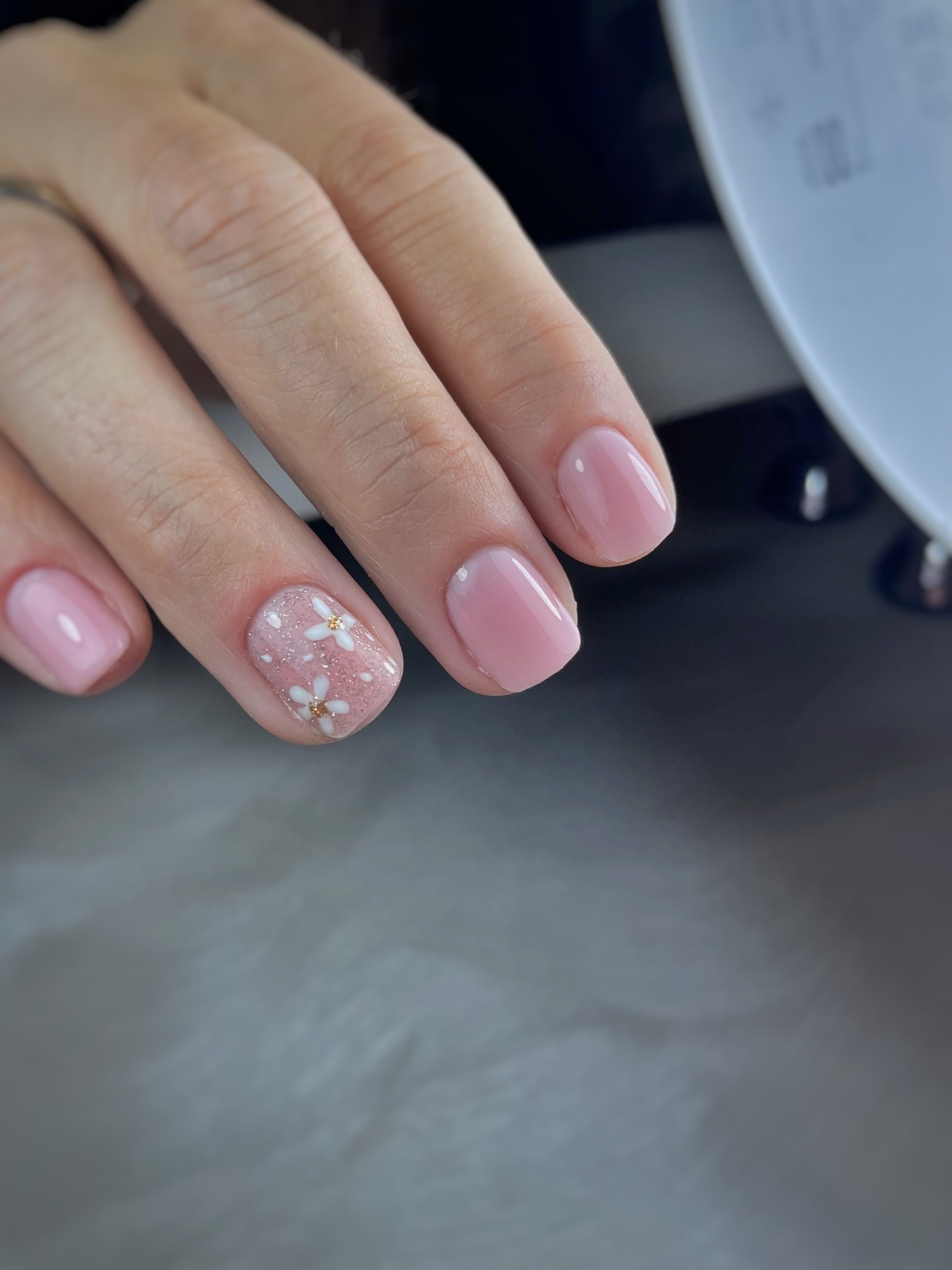 Lichtroze nagels met een subtiel glinsterend accent